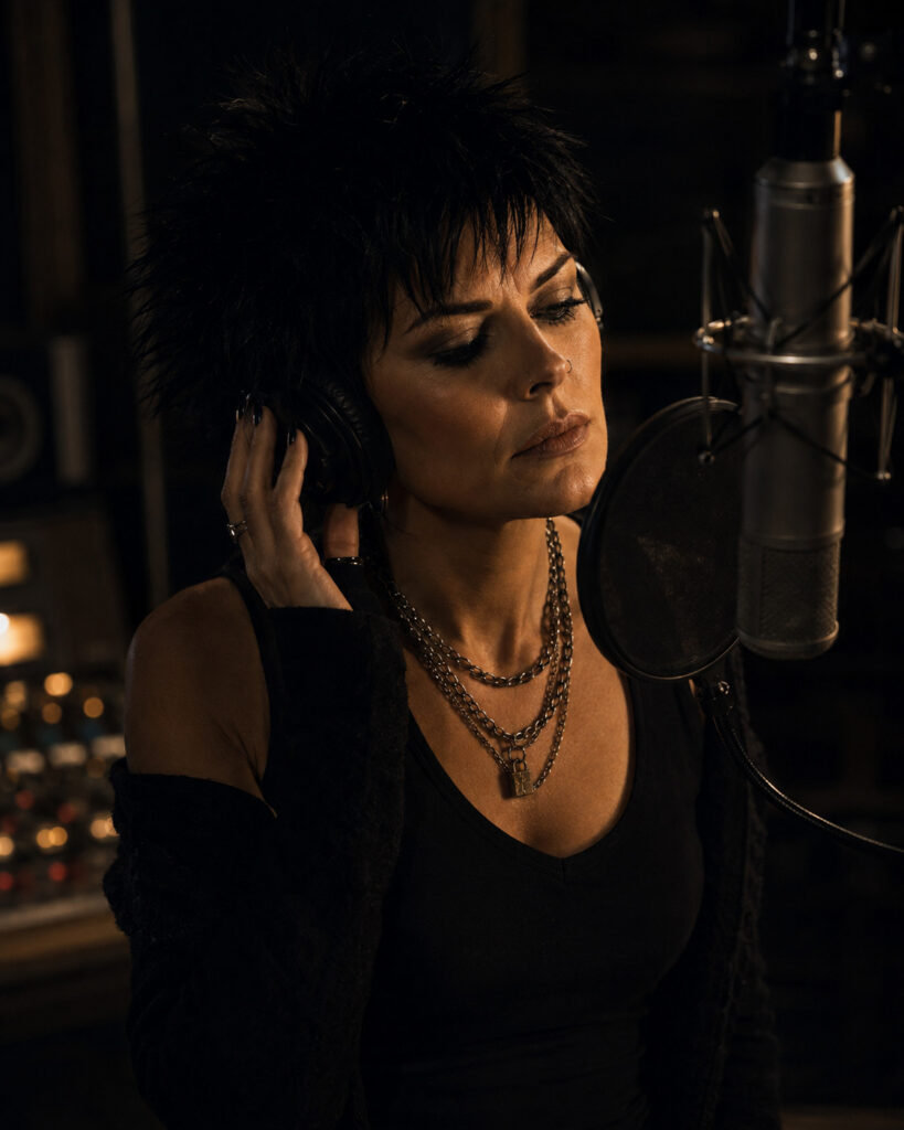 YLSHAA recording vocals in a dark studio